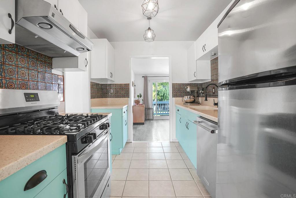 511 El Monte Road El Cajon, CA 92020 - Photo 21 of 30 a kitchen with stainless steel appliances granite countertop a stove a sink dishwasher and a refrigerator