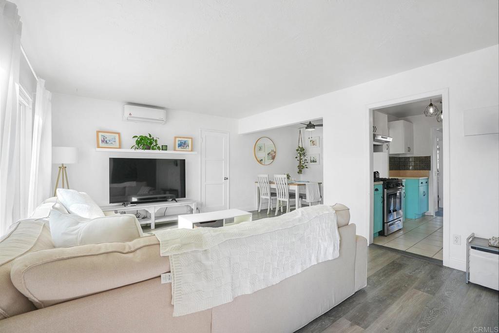 511 El Monte Road El Cajon, CA 92020 - Photo 24 of 30 a living room with furniture a flat screen tv and a fireplace