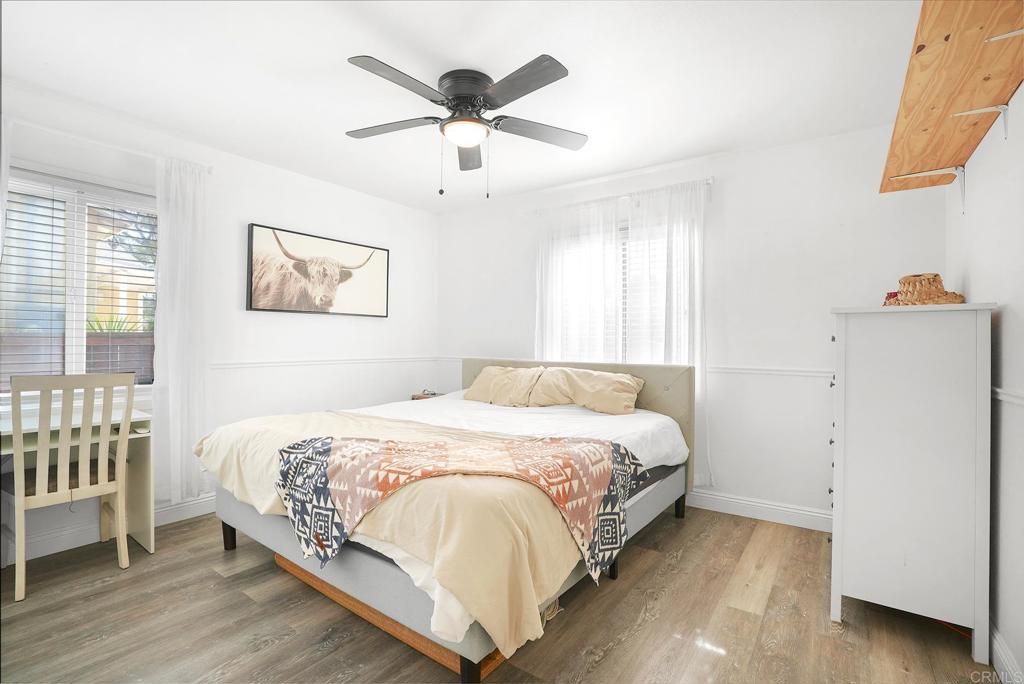 511 El Monte Road El Cajon, CA 92020 - Photo 29 of 30 a bedroom with a bed and a chandelier