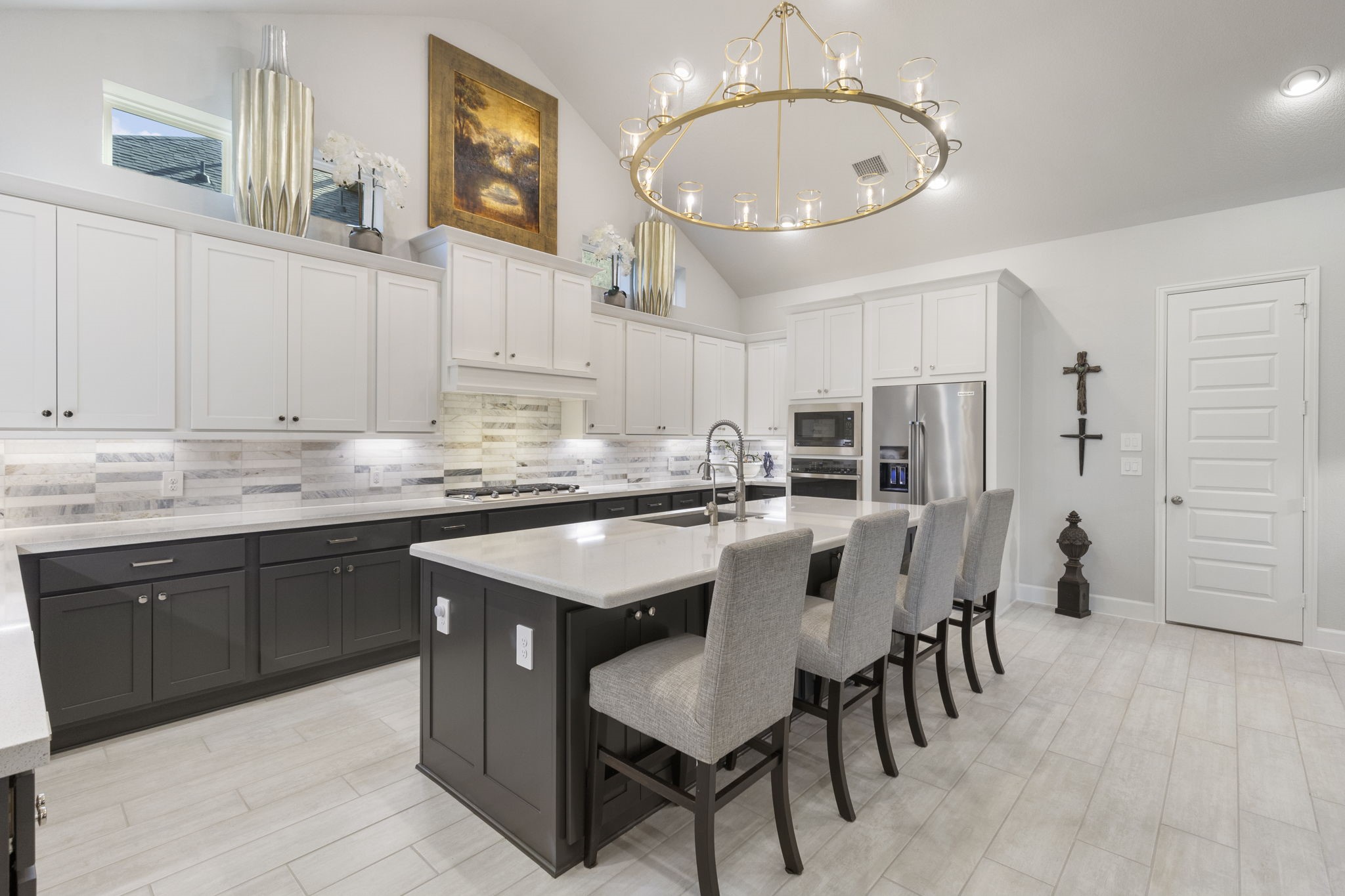 15423 Ringbill Way Magnolia, TX 77354 - Photo 17 of 50 a kitchen with cabinets a sink stainless steel appliances and dining table
