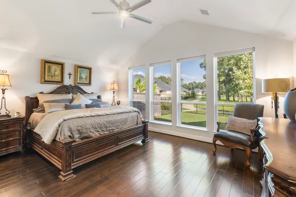 a bedroom with a bed and a large window