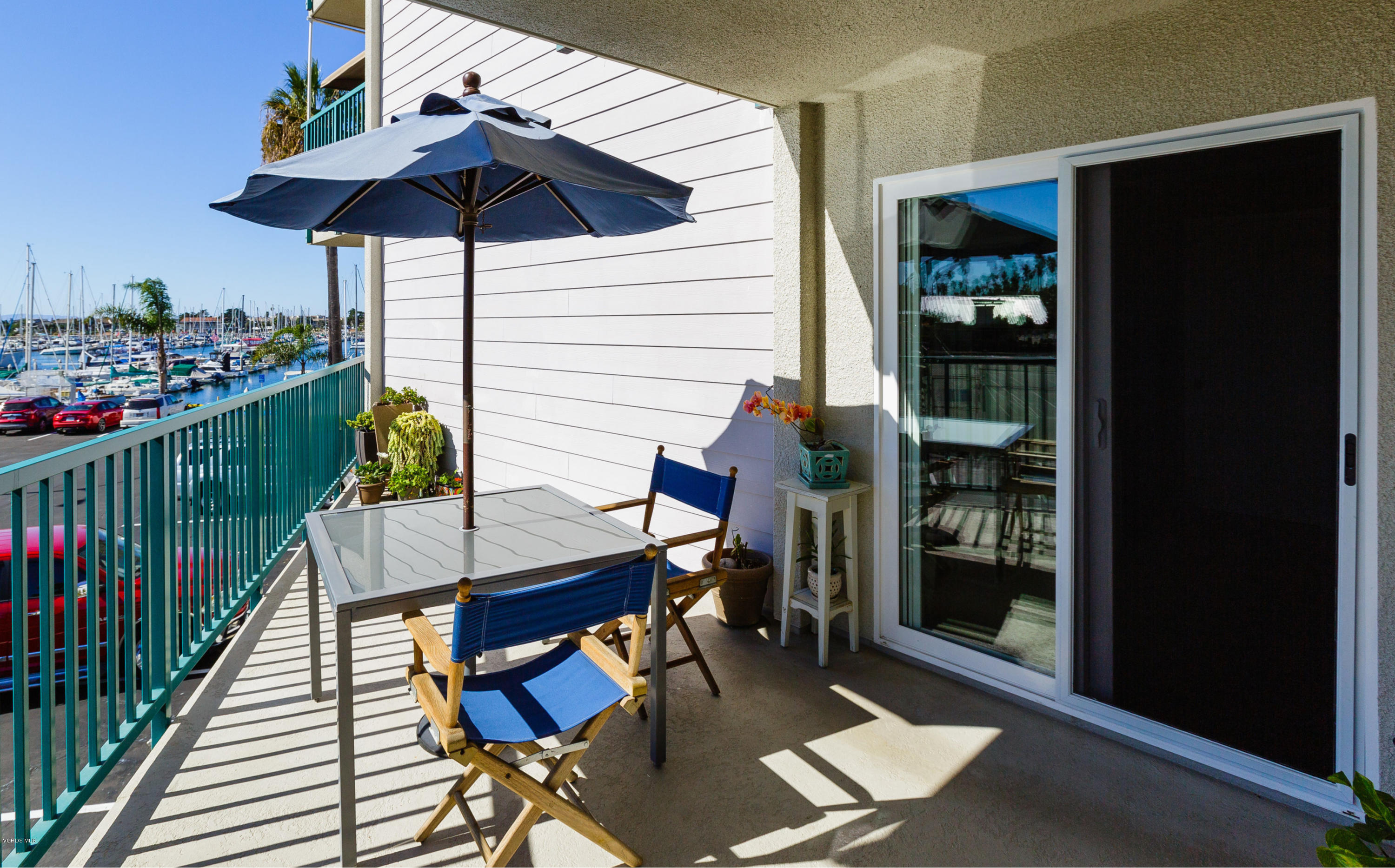 3101 Peninsula Road, Unit 105 Oxnard, CA 93035 - Photo 3 of 36 a view of balcony filled with furniture and umbrella