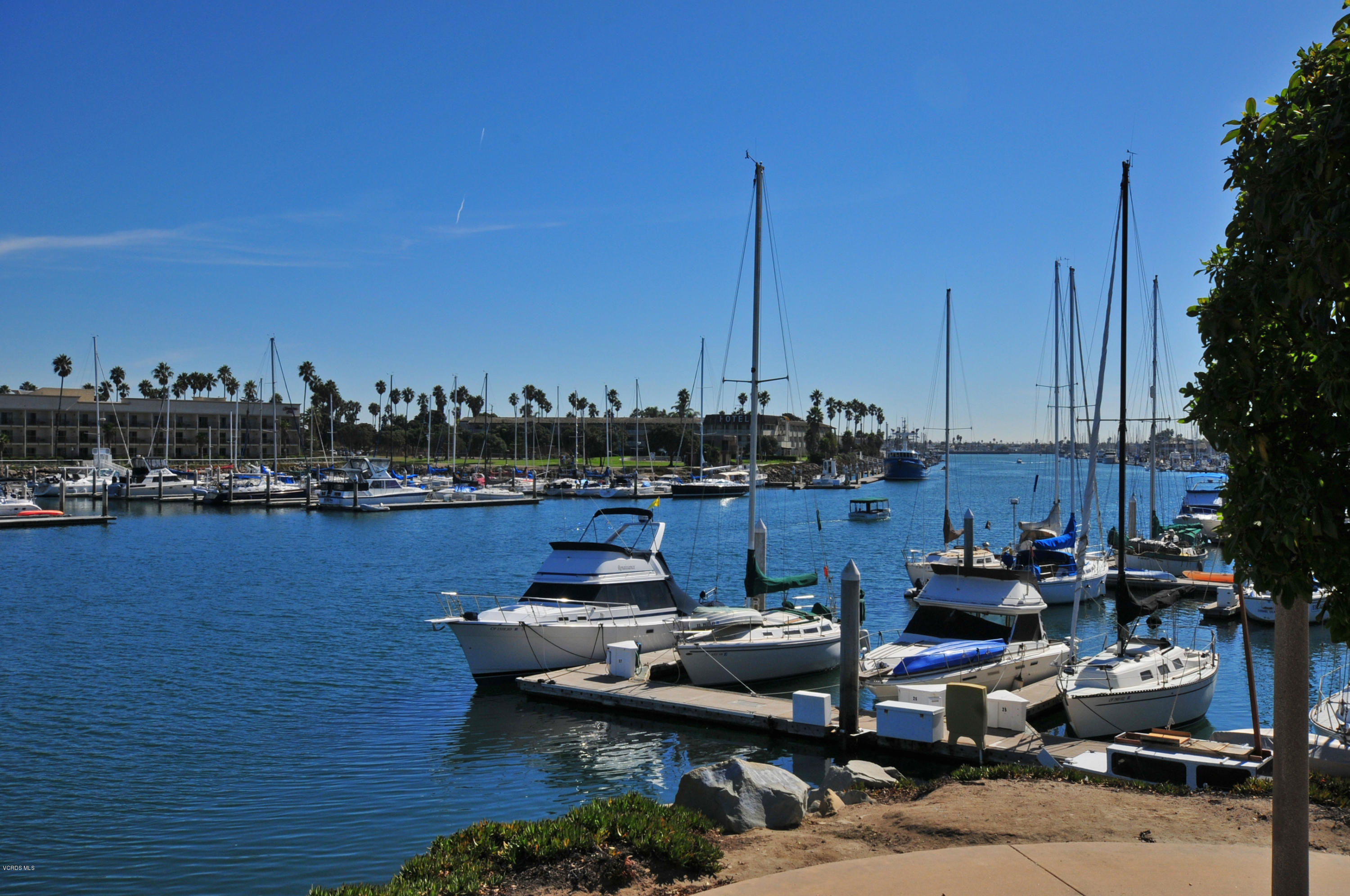 3101 Peninsula Road, Unit 105 Oxnard, CA 93035 - Photo 24 of 36 a view of a lake with boats and a table and chairs