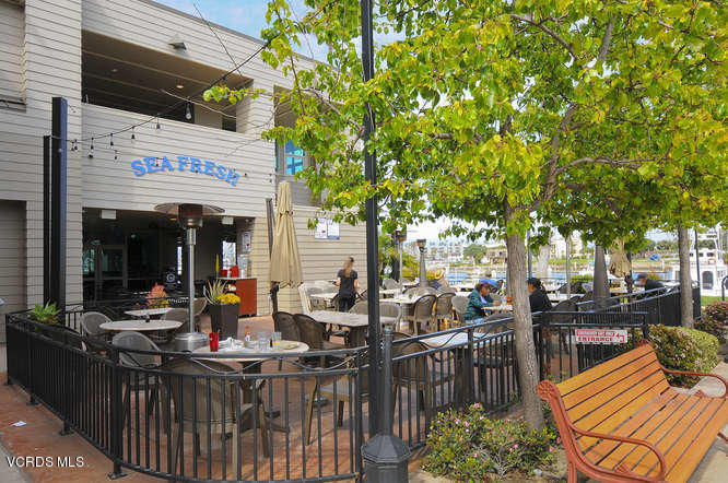 3101 Peninsula Road, Unit 105 Oxnard, CA 93035 - Photo 35 of 36 a view of a chairs and table in patio with a barbeque