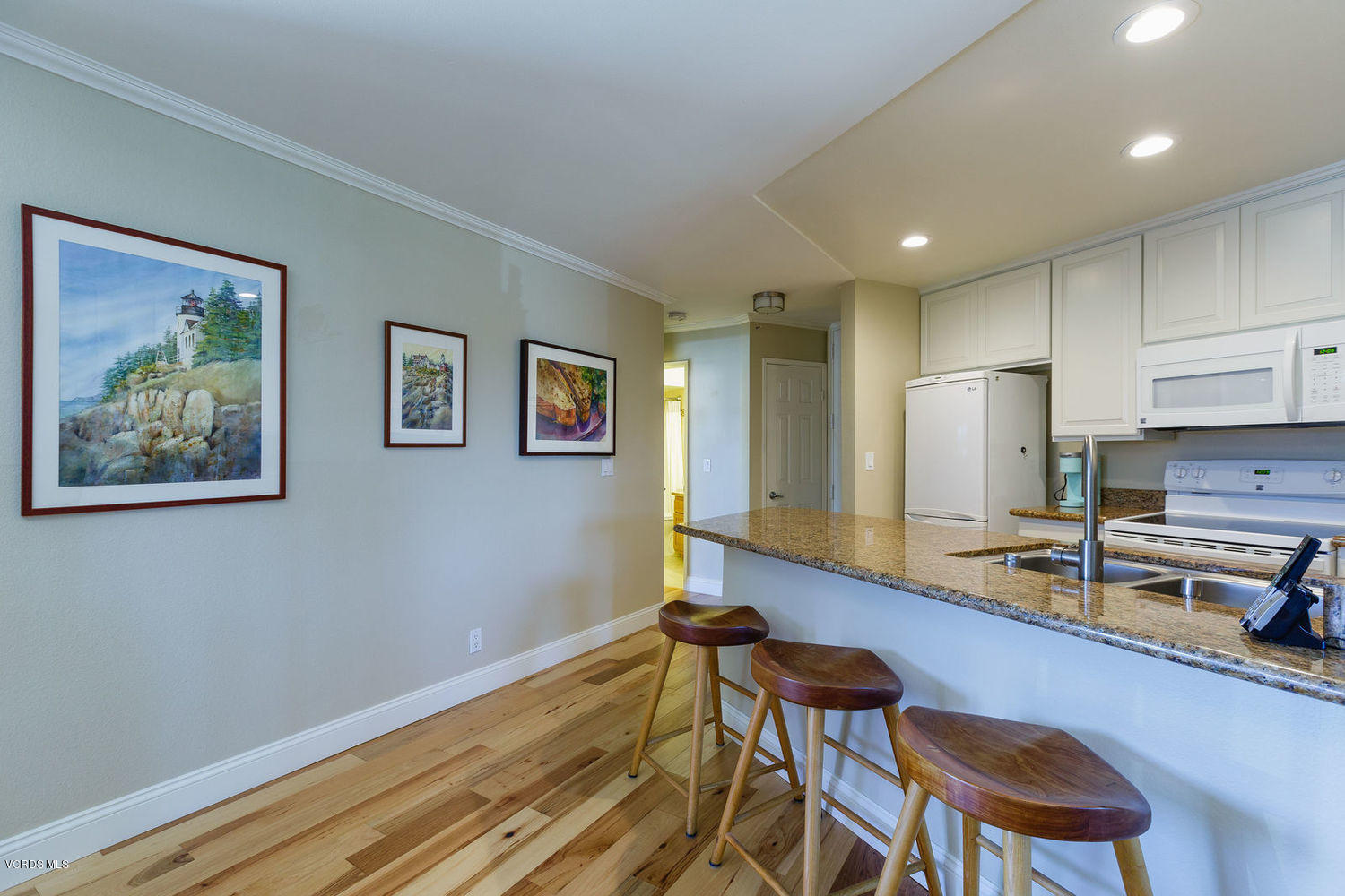 3101 Peninsula Road, Unit 105 Oxnard, CA 93035 - Photo 5 of 36 a kitchen with a sink and chairs