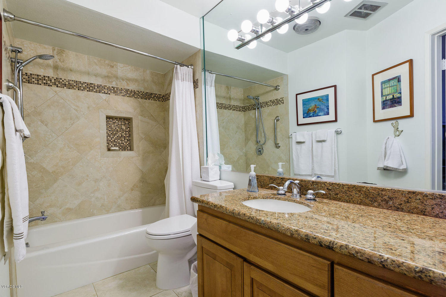 3101 Peninsula Road, Unit 105 Oxnard, CA 93035 - Photo 6 of 36 a bathroom with a granite countertop sink a toilet a mirror a bathtub and shower