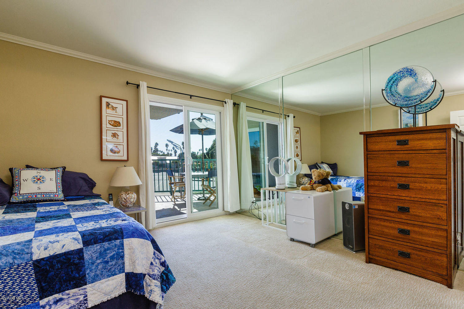 3101 Peninsula Road, Unit 105 Oxnard, CA 93035 - Photo 7 of 36 a bedroom with a bed and large windows
