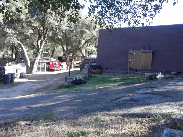 a backyard of a house with a yard and outdoor seating