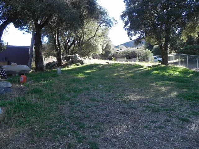 a view of a livingroom with a ceiling fan and window