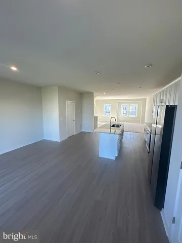 a view of kitchen with wooden floor and electronic appliances