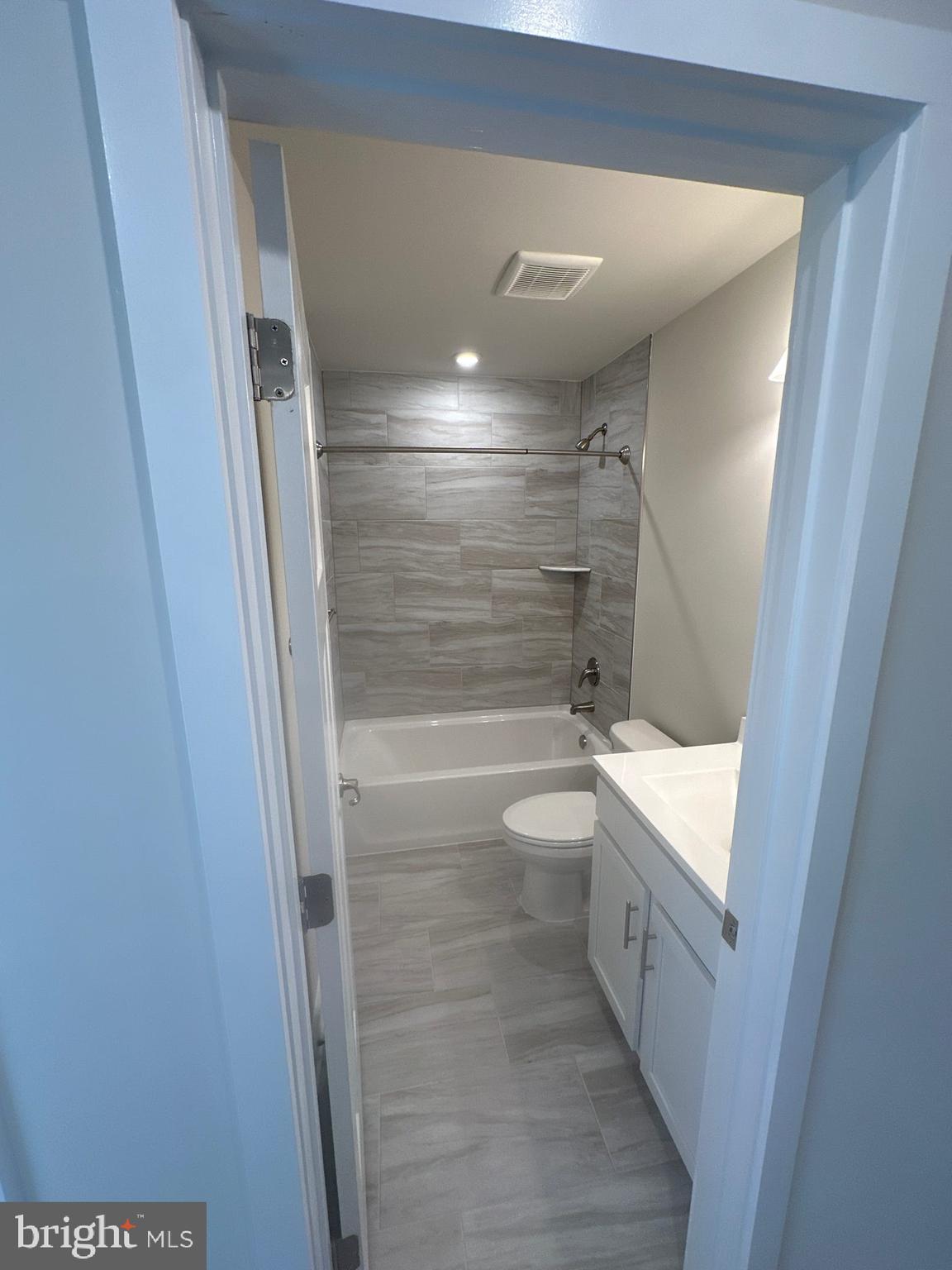 29 Trotting Road Inwood, WV 25428 - Photo 16 of 19 a bathroom with a granite countertop sink a toilet and shower