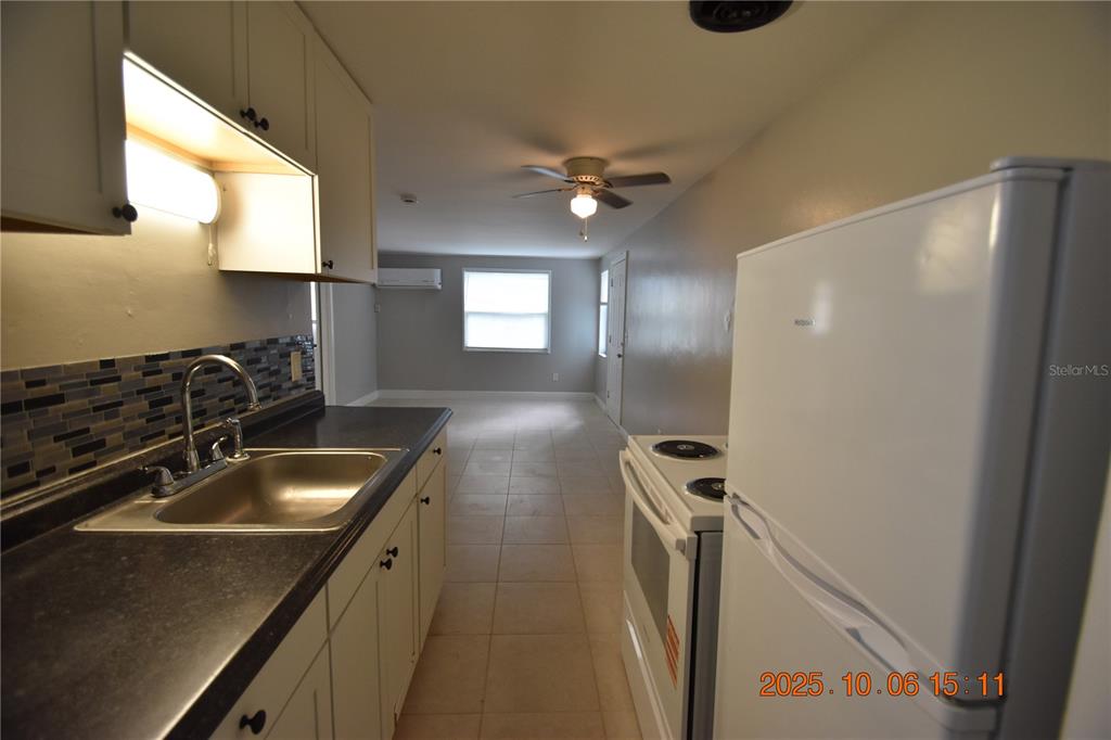 401 Milwaukee Avenue, Unit 401 Dunedin, FL 34698 - Photo 12 of 23 a kitchen with a sink stove and refrigerator