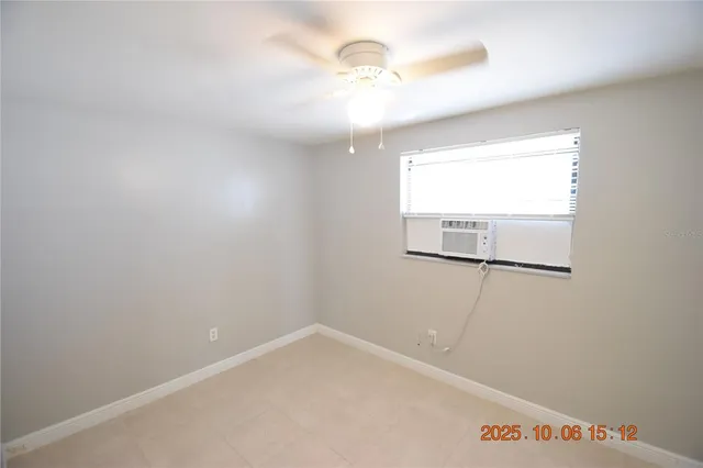 an empty room with fan and entrance