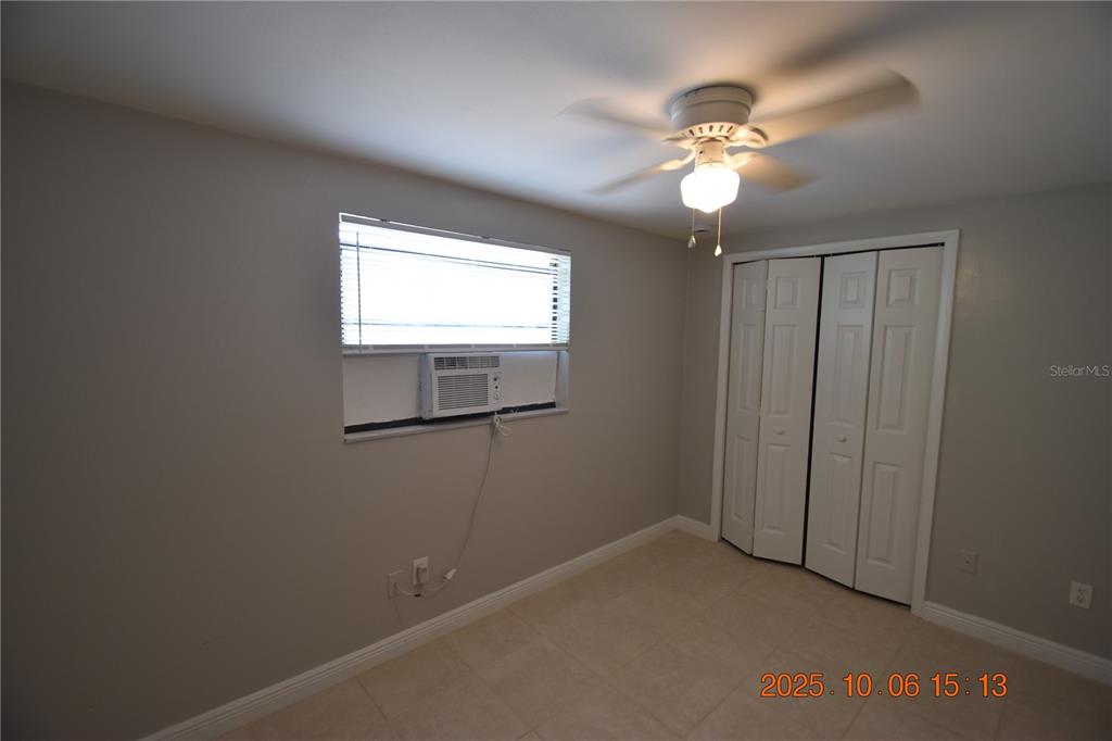 401 Milwaukee Avenue, Unit 401 Dunedin, FL 34698 - Photo 16 of 23 an empty room with windows and fan