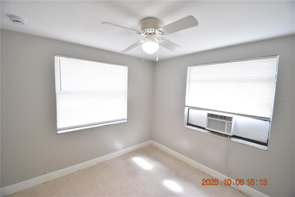 401 Milwaukee Avenue, Unit 401 Dunedin, FL 34698 - Photo 19 of 23 a view of an empty room with wooden floor and a window