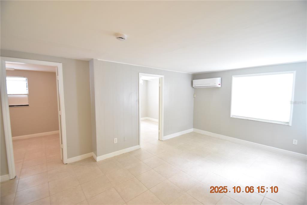 401 Milwaukee Avenue, Unit 401 Dunedin, FL 34698 - Photo 10 of 23 an empty room with windows and closet
