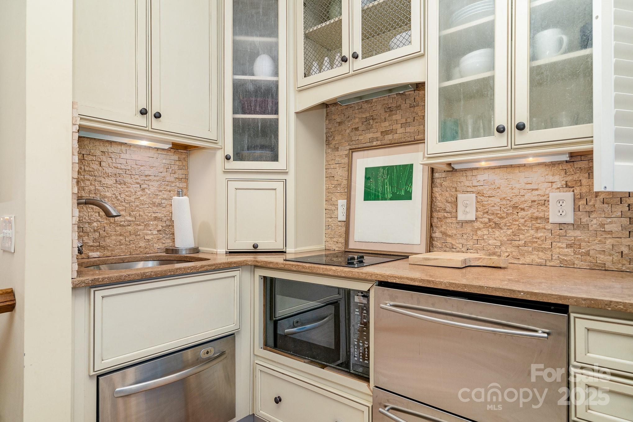 2120 Malvern Road Charlotte, NC 28207 - Photo 39 of 48 a kitchen with stainless steel appliances granite countertop a sink and cabinets