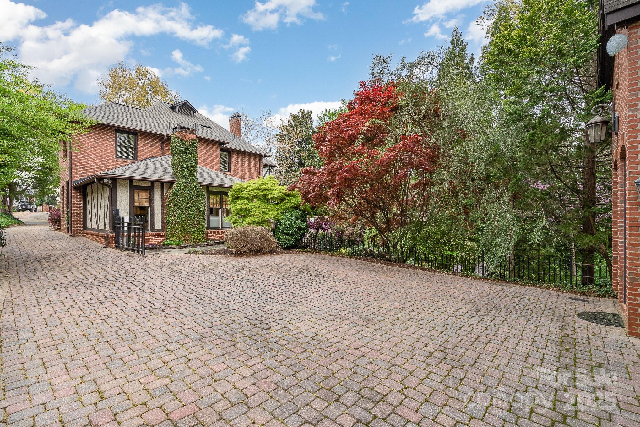 2120 Malvern Road Charlotte, NC 28207 - Photo 45 of 48 a front view of a house with a yard and a garage