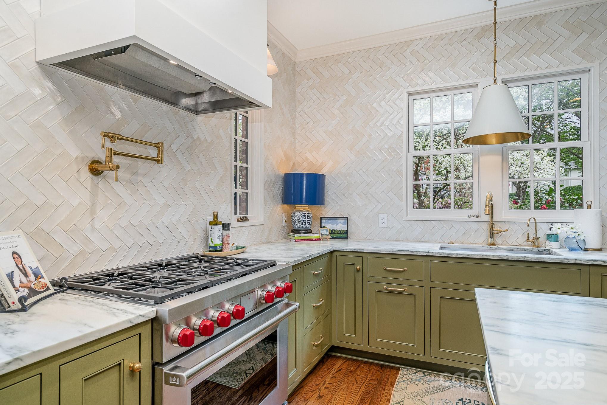 2120 Malvern Road Charlotte, NC 28207 - Photo 10 of 48 a kitchen with a stove and a sink