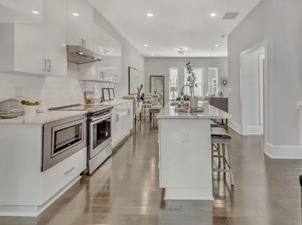 a kitchen with a stove a sink and a refrigerator