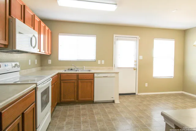 a kitchen with a stove a sink and a refrigerator