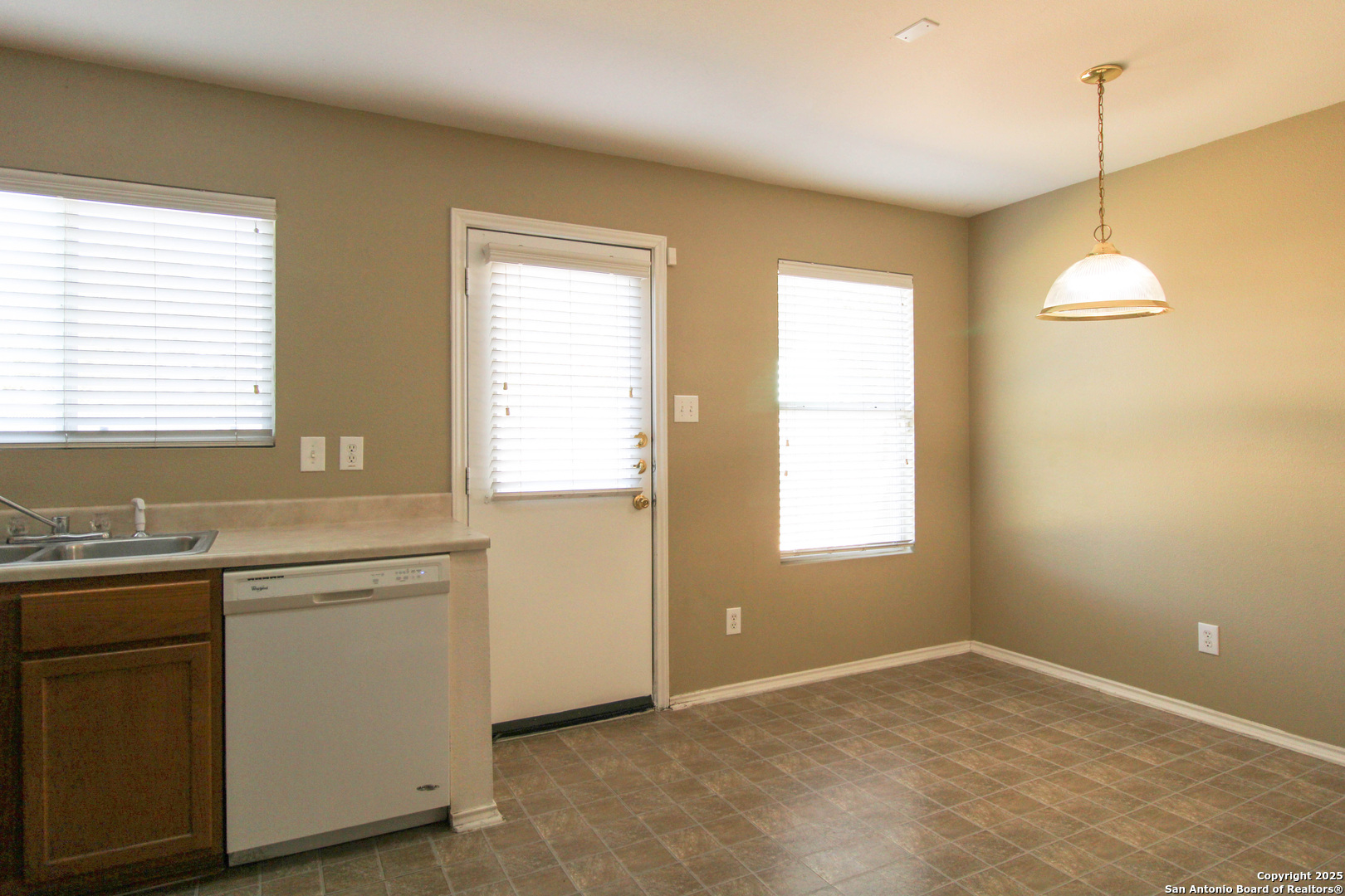 20823 Blue Trinity San Antonio, TX 78259 - Photo 12 of 46 a view of a kitchen with a sink and dishwasher cabinet