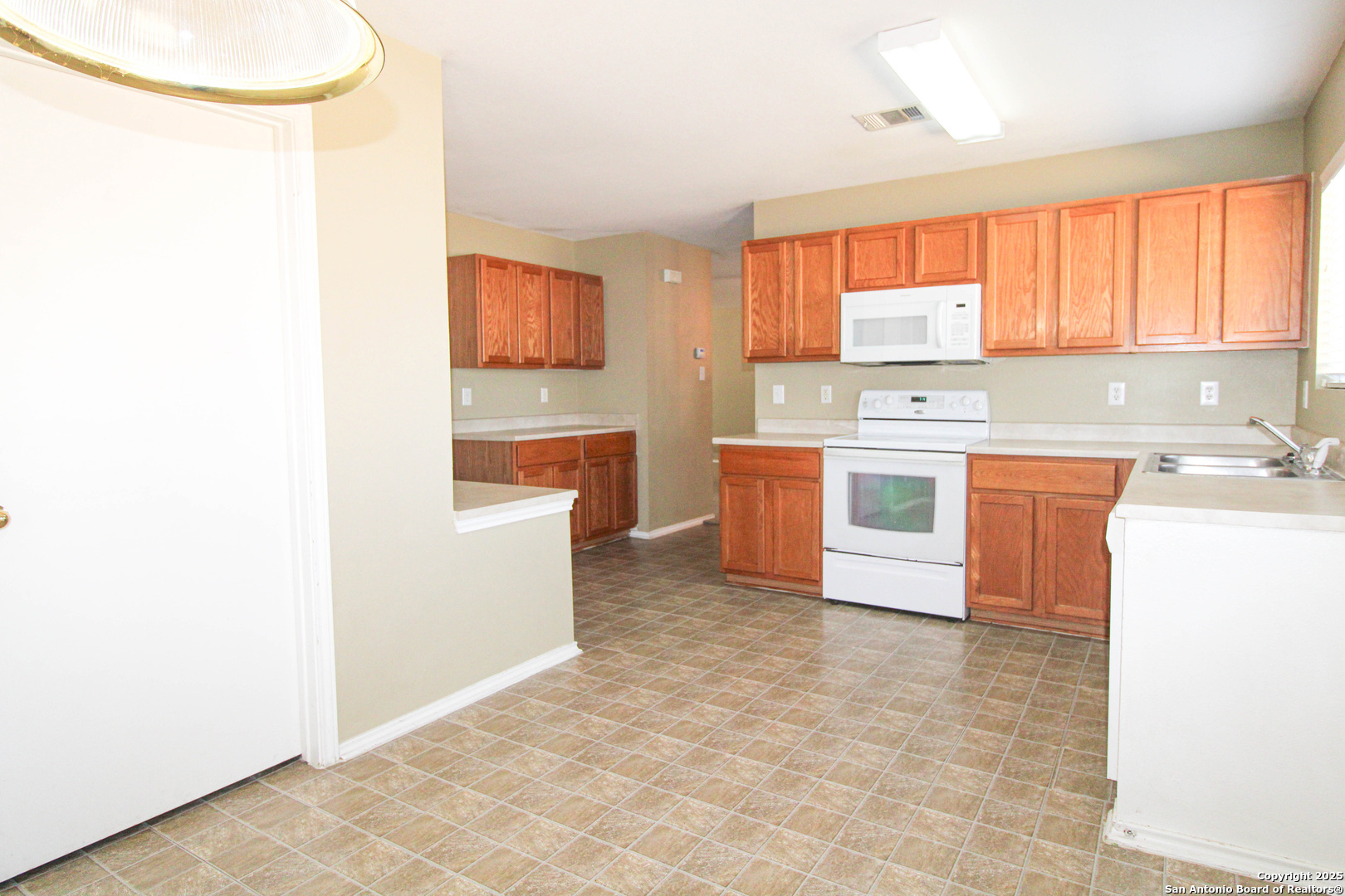 20823 Blue Trinity San Antonio, TX 78259 - Photo 13 of 46 a kitchen with stainless steel appliances a stove top oven
