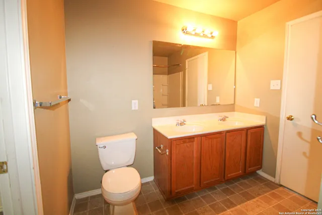 a bathroom with a sink a toilet and mirror