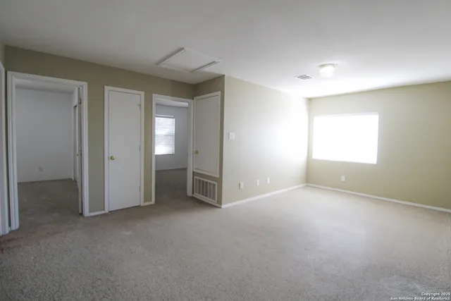 an empty room with windows and closet