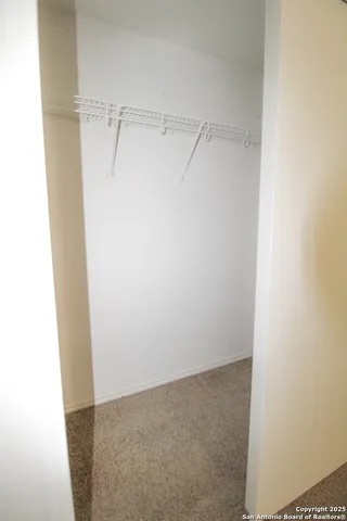 an empty room with a empty space and windows