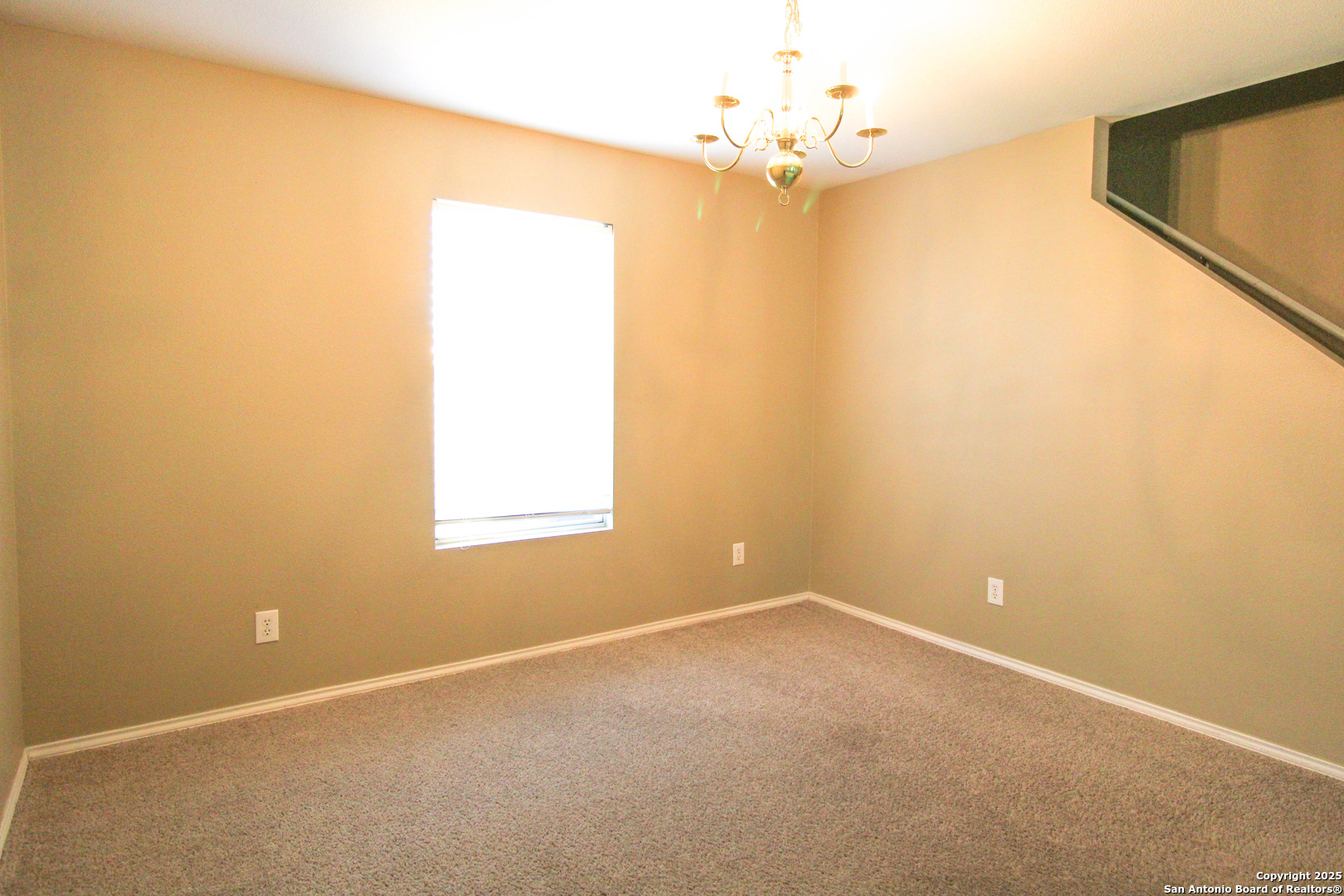 20823 Blue Trinity San Antonio, TX 78259 - Photo 8 of 46 an empty room with a chandelier fan and windows