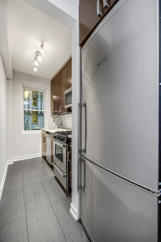 a living room with furniture a front door and a window
