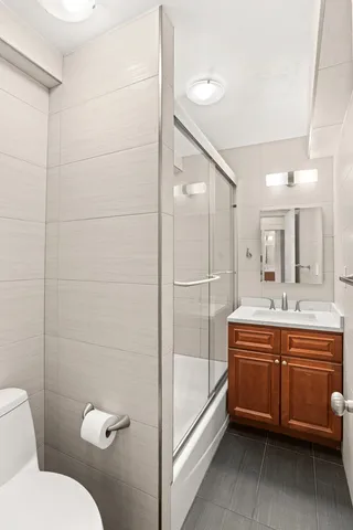 a bedroom with a bed and a potted plant