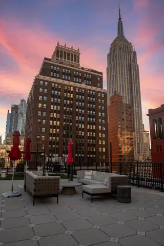 a spacious bedroom with a bed and a chandelier