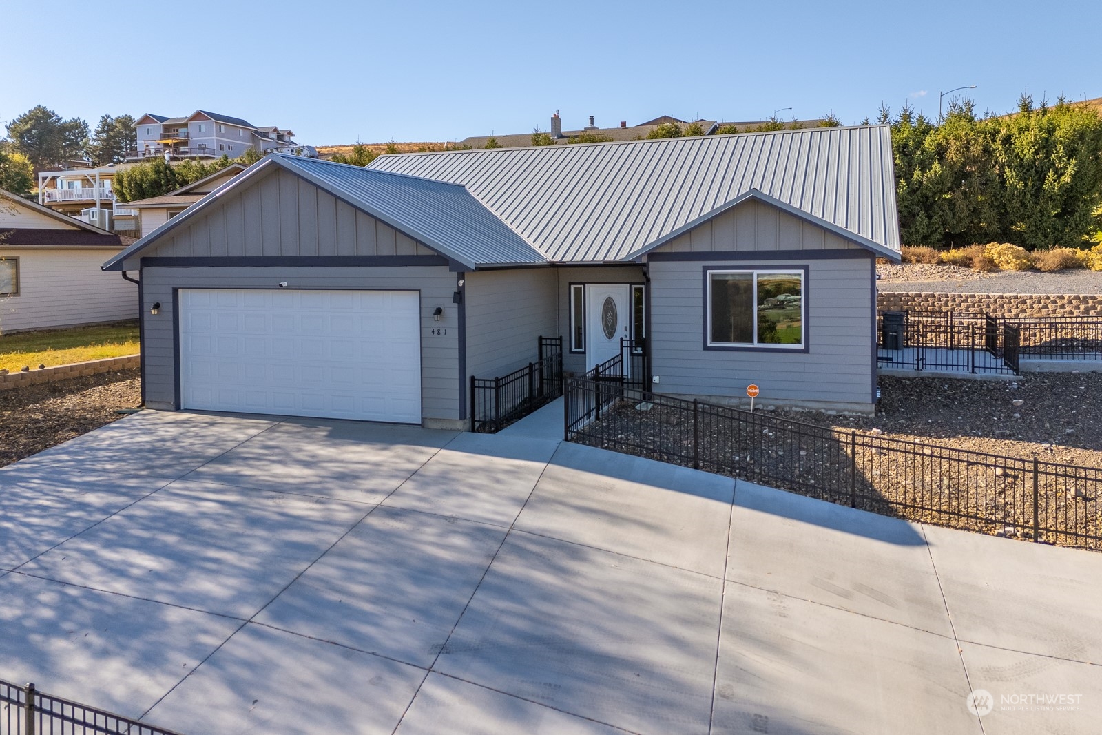 481 Patrick Road Ephrata, WA 98823 - Photo 36 of 39 a front view of a house with a yard and garage