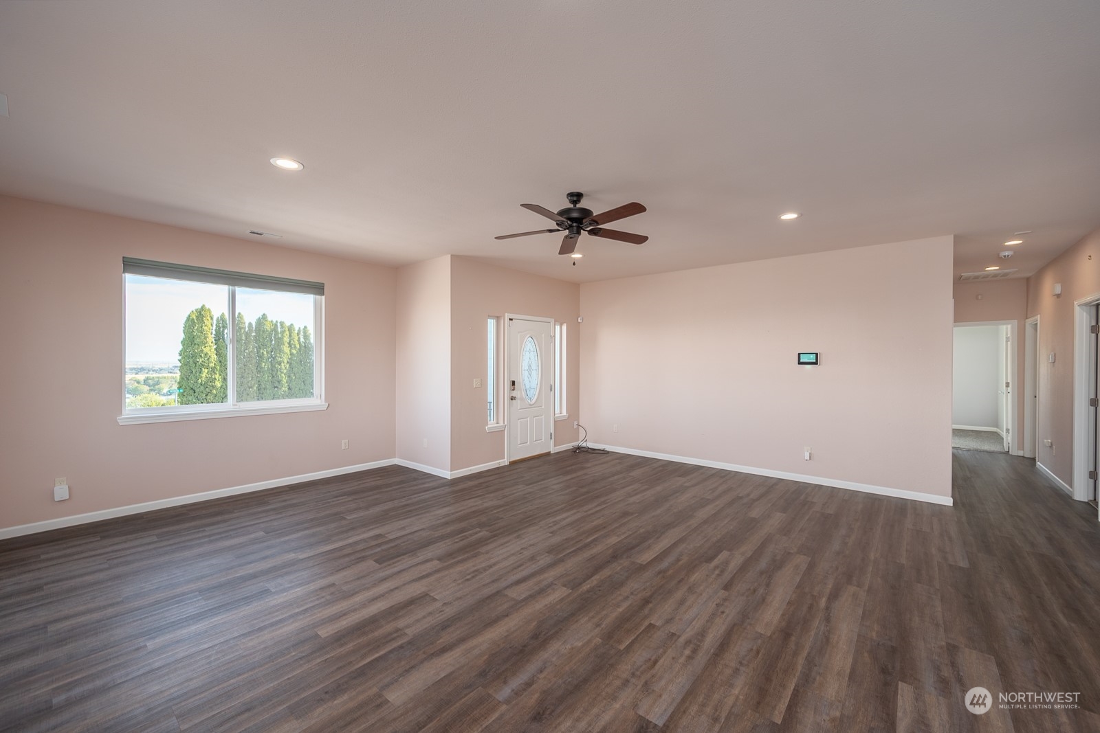 481 Patrick Road Ephrata, WA 98823 - Photo 7 of 39 an empty room with wooden floor and windows