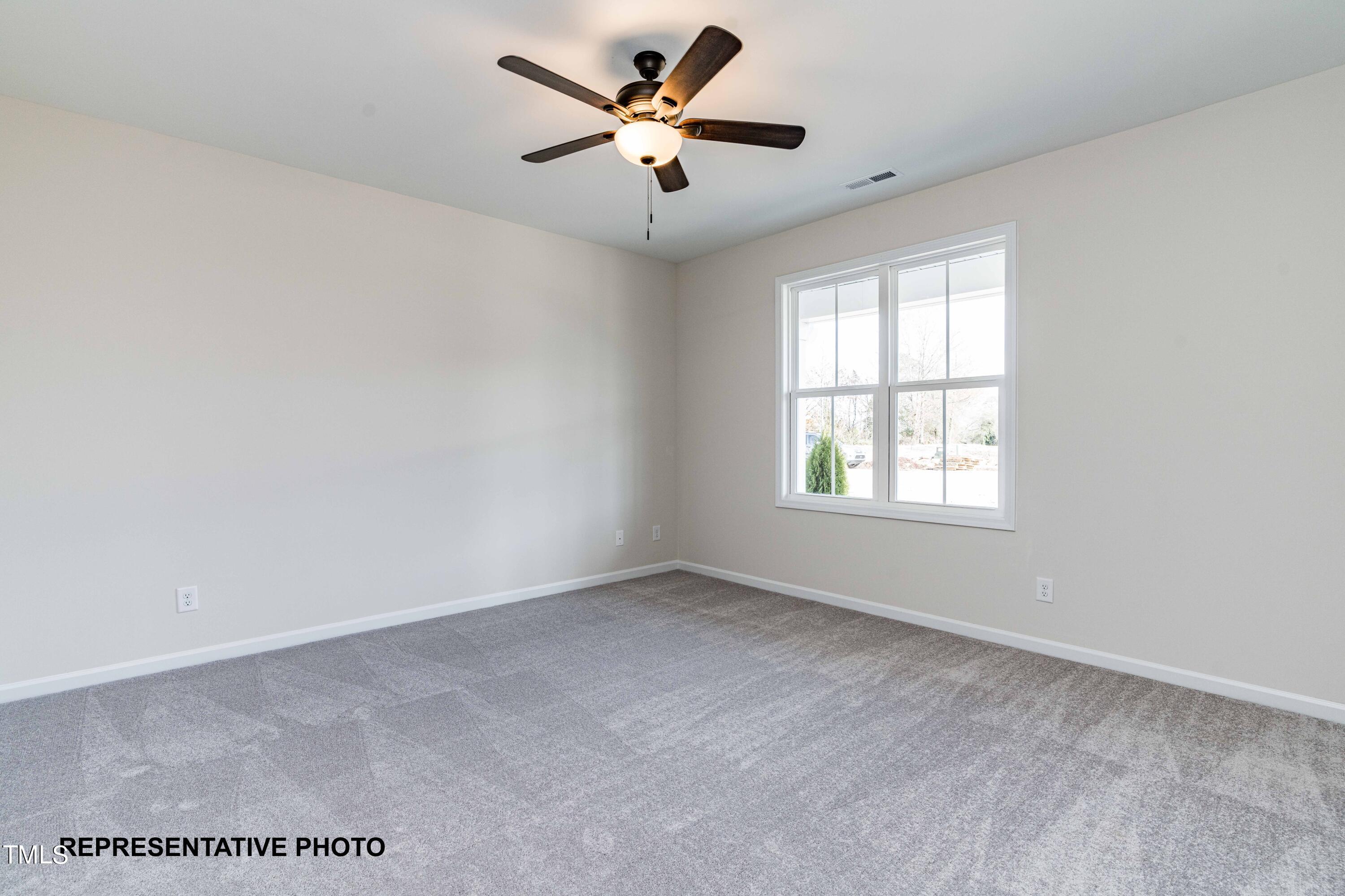 112 Springtooth Drive Zebulon, NC 27597 - Photo 7 of 10 a view of an empty room with a window