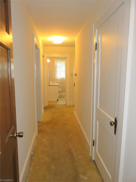 4744 Germanton Road Winston-Salem, NC 27105 - Photo 8 of 25 Hallway leads to two bedrooms and full bath on main level - many rooms recently painted