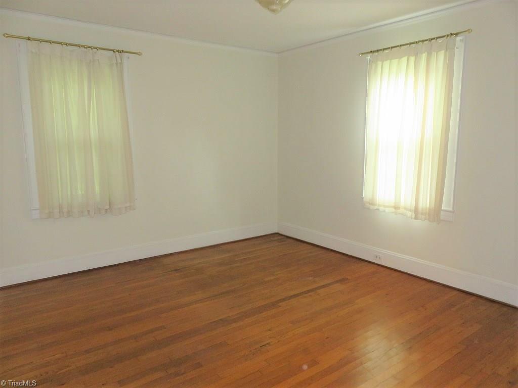 4744 Germanton Road Winston-Salem, NC 27105 - Photo 9 of 25 Master bedroom main level with wood floors - appears to have wood under carpet but buyer must confirm