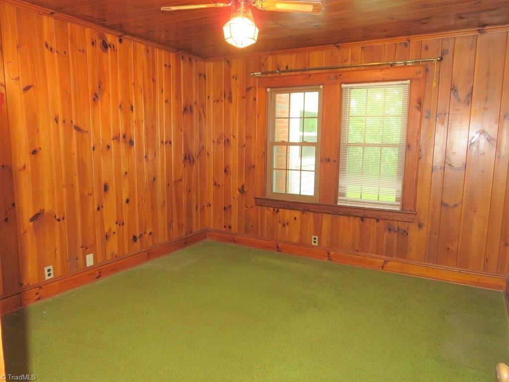 4744 Germanton Road Winston-Salem, NC 27105 - Photo 10 of 25 2nd bedroom located on main level - rich wood paneled walls and ceiling