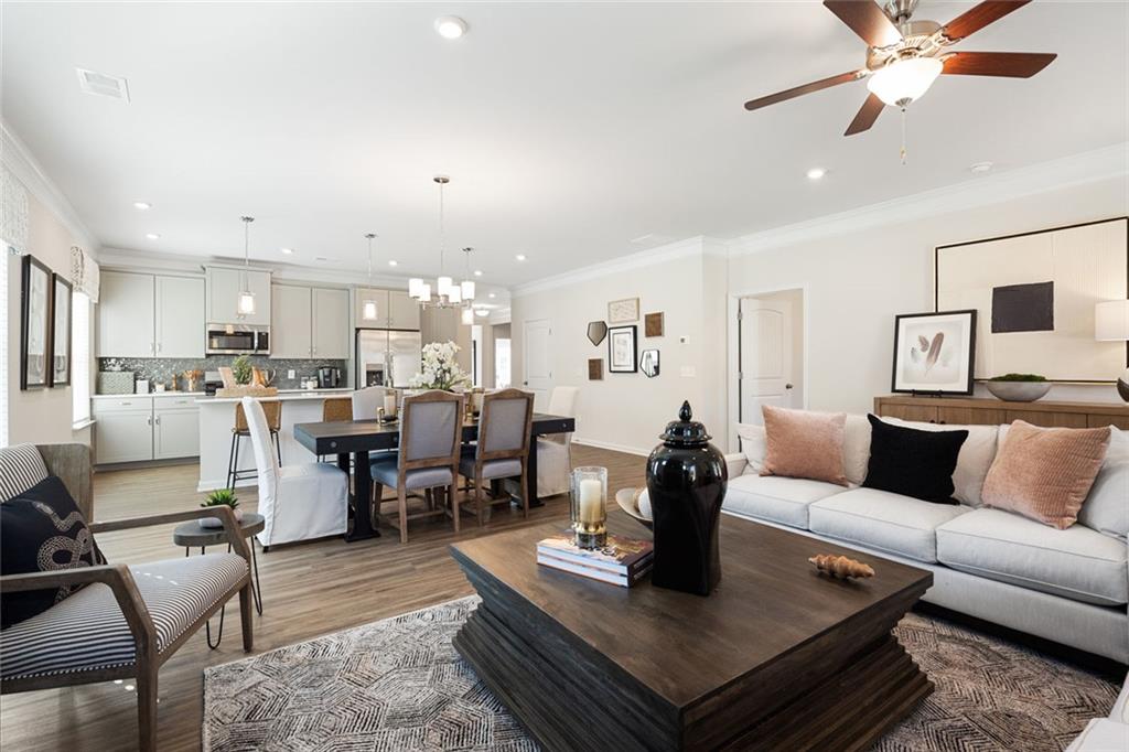 730 Sinclair Lane Temple, GA 30179 - Photo 23 of 37 a living room with furniture kitchen view and a chandelier