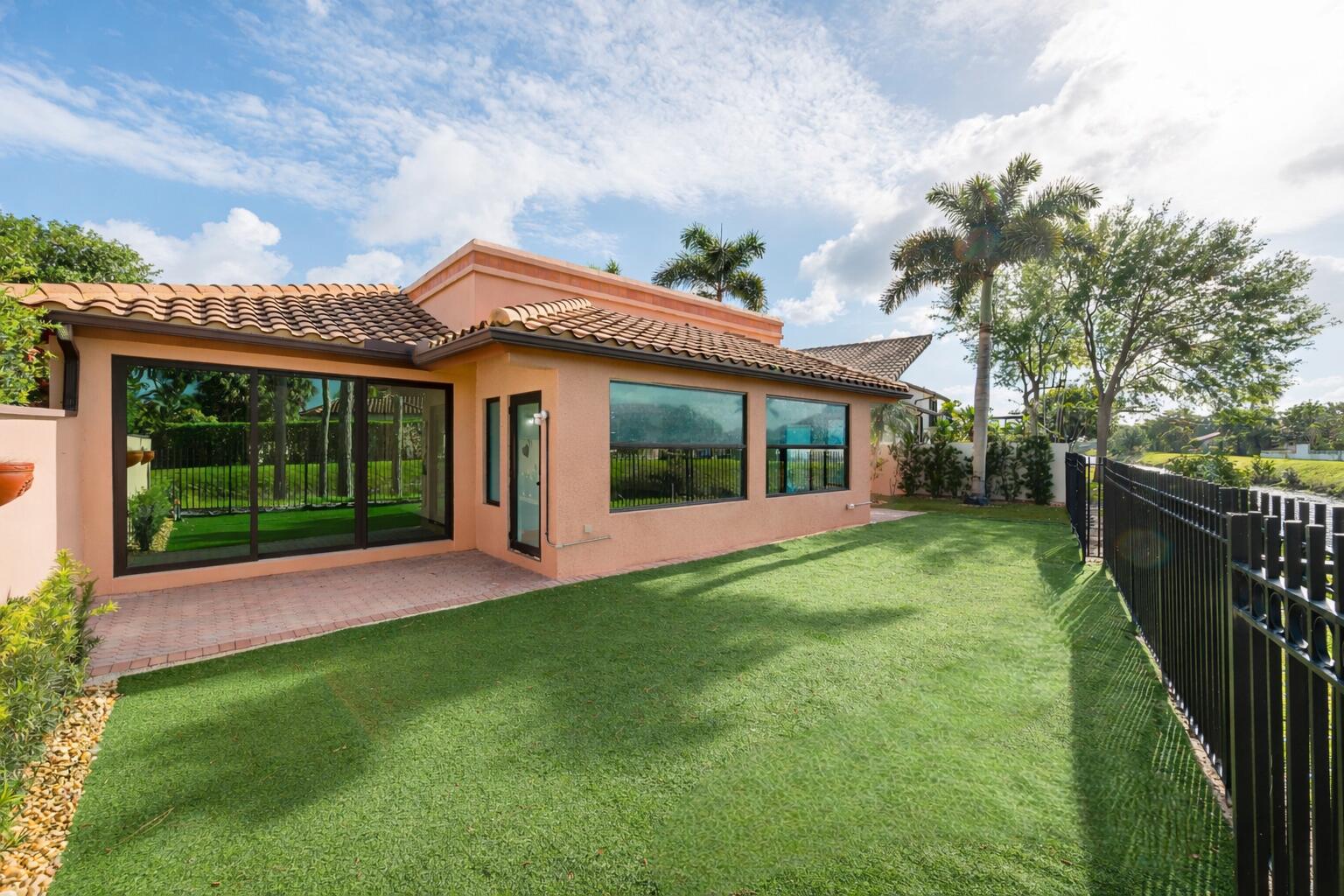 6388 Via Rosa Boca Raton, FL 33433 - Photo 43 of 49 a view of a house with a yard and a garden