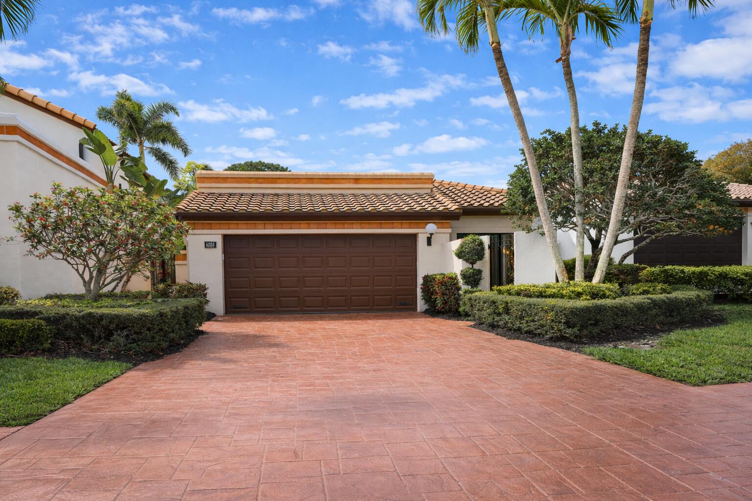 6388 Via Rosa Boca Raton, FL 33433 - Photo 9 of 49 a front view of a house with a yard and garage