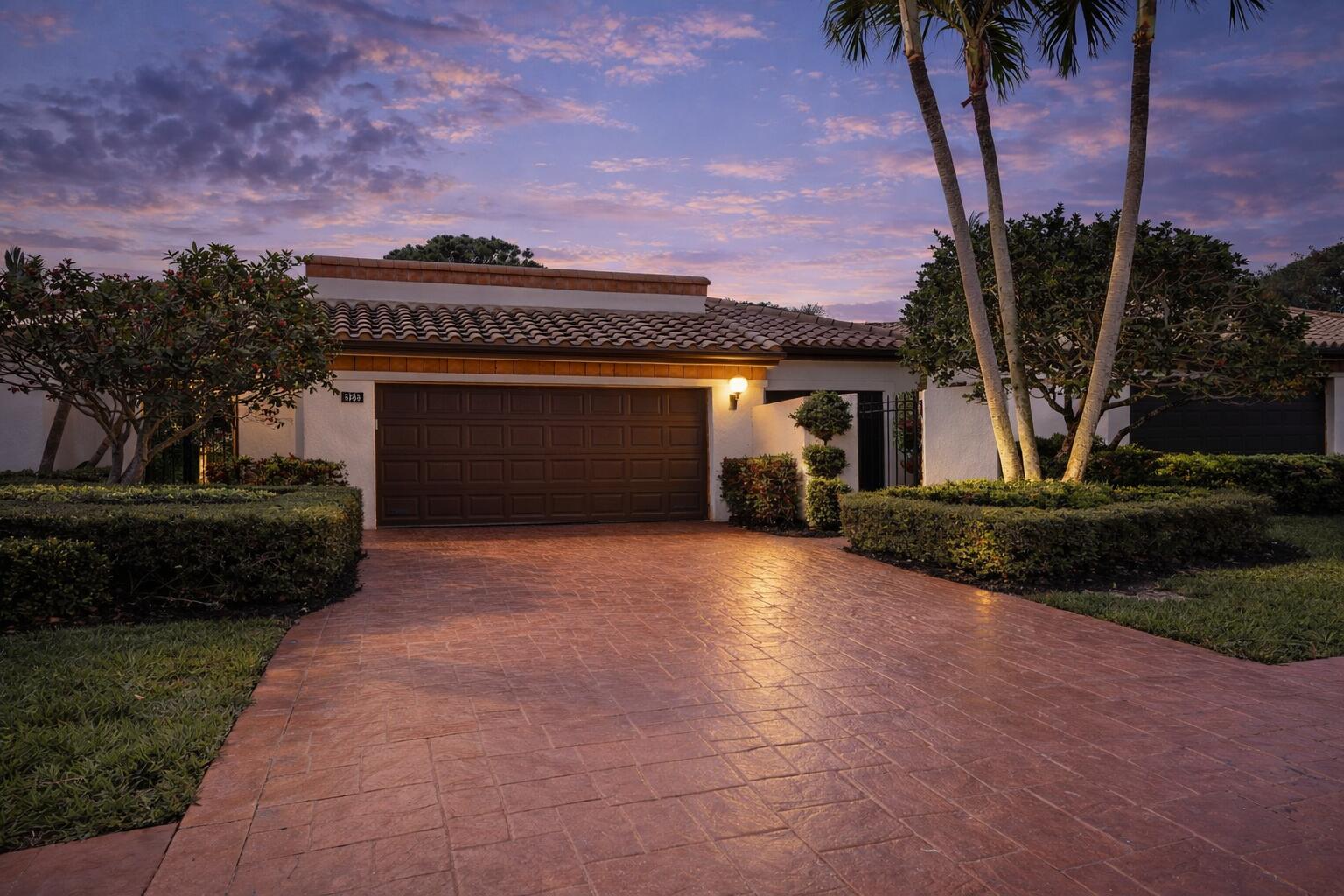 6388 Via Rosa Boca Raton, FL 33433 - Photo 10 of 49 a front view of a house with a garden and a yard