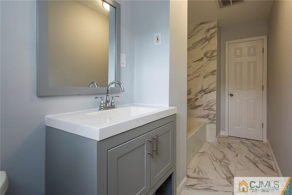 26 Purdue Road Old Bridge, NJ 08859 - Photo 12 of 21 a sink vanity and a mirror