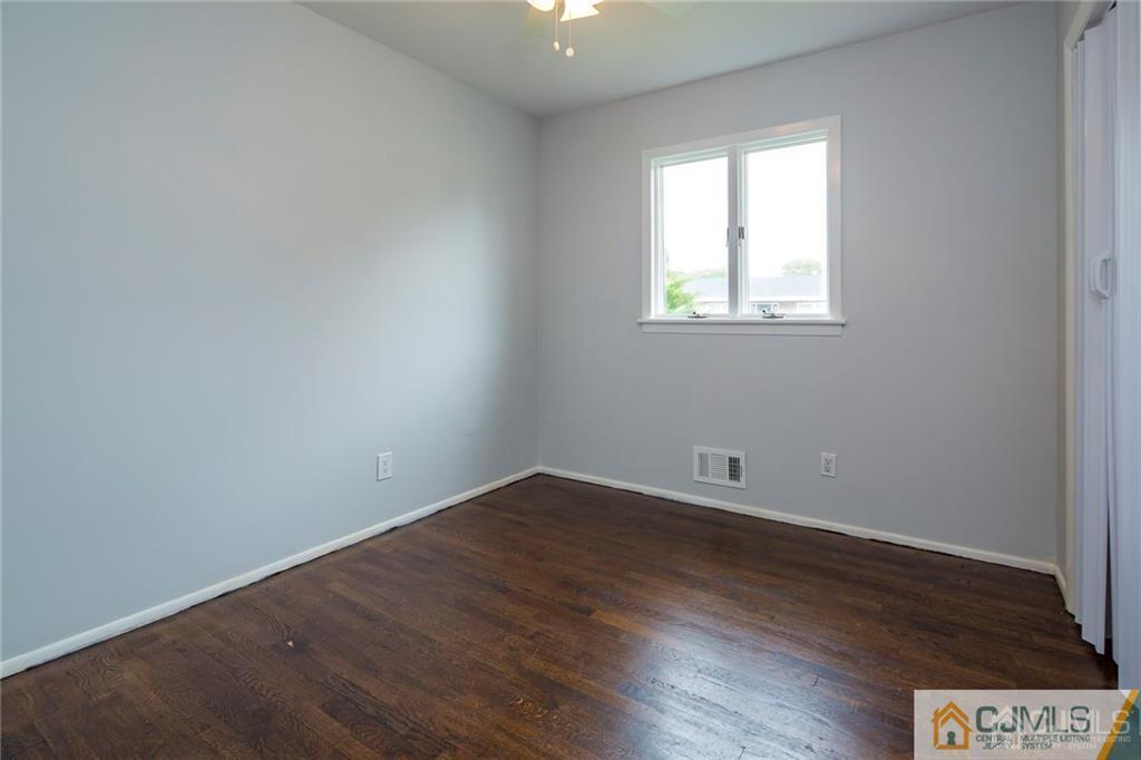 26 Purdue Road Old Bridge, NJ 08859 - Photo 16 of 21 an empty room with wooden floor and windows
