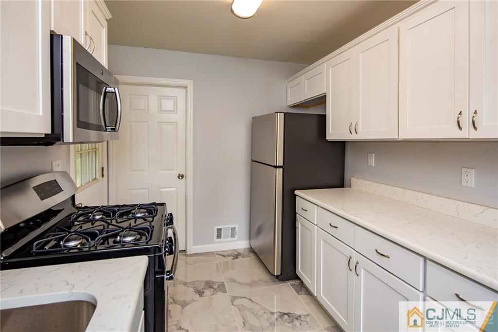 26 Purdue Road Old Bridge, NJ 08859 - Photo 10 of 21 a kitchen with a refrigerator and a stove top oven