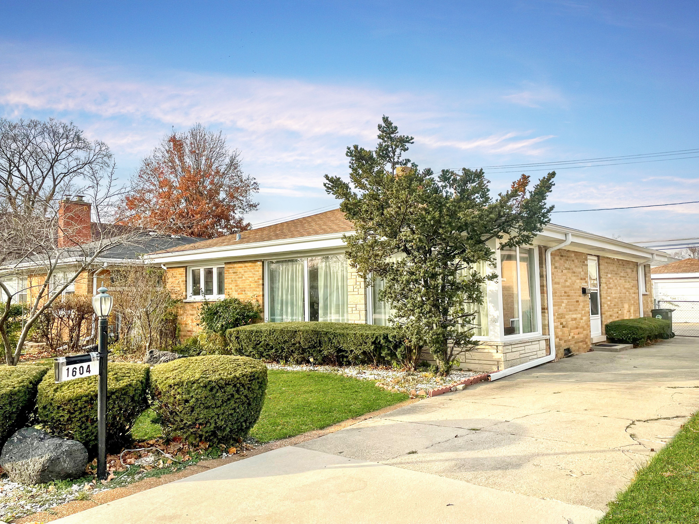 1604 Oakton Street Park Ridge, IL 60068 - Photo 1 of 23 a front view of a house with a yard and potted plants