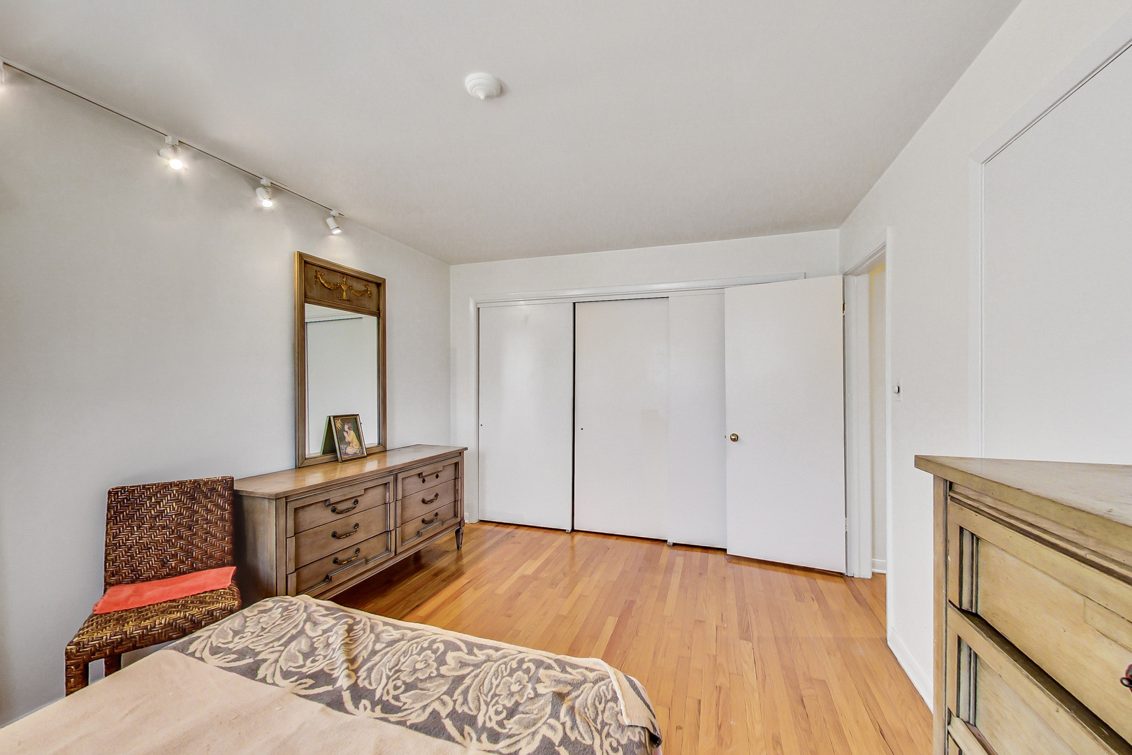 1604 Oakton Street Park Ridge, IL 60068 - Photo 11 of 23 a spacious bedroom with a bed and wooden floor