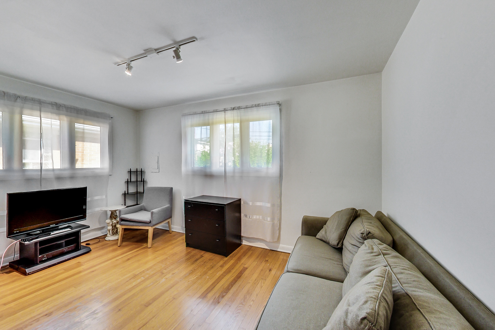 1604 Oakton Street Park Ridge, IL 60068 - Photo 14 of 23 a living room with furniture a flat screen tv and a fireplace